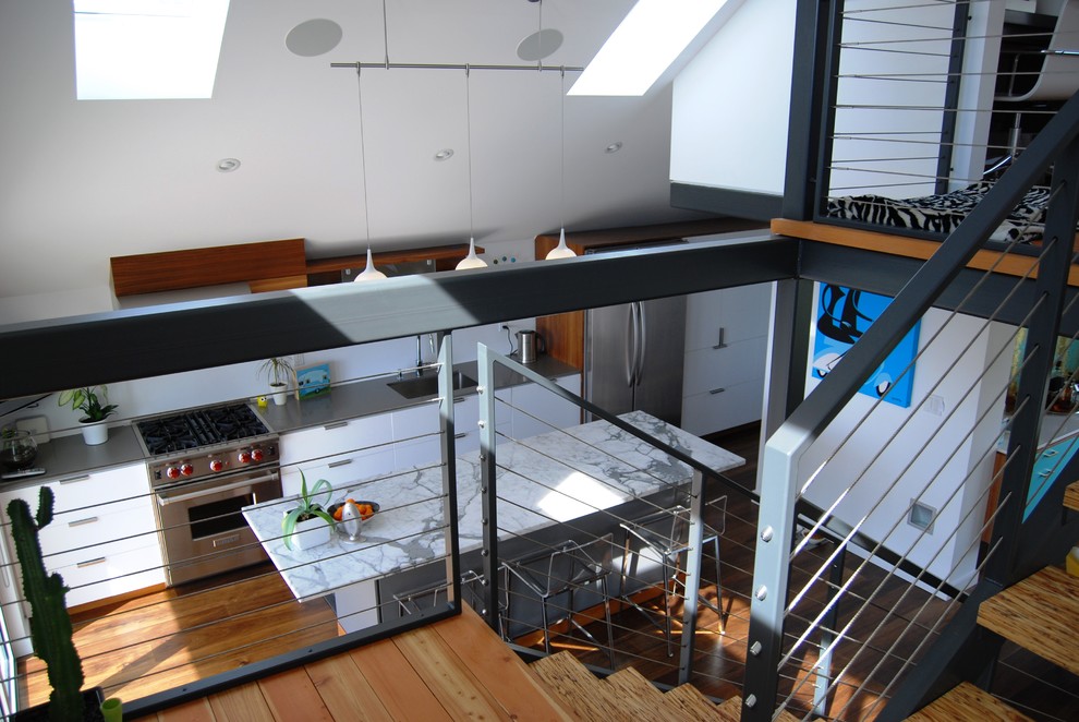 Свежая идея для дизайна: прямая кухня в современном стиле с одинарной мойкой, плоскими фасадами, белыми фасадами, мраморной столешницей и техникой из нержавеющей стали - отличное фото интерьера