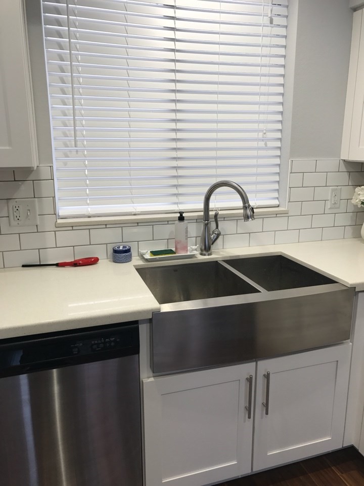 Photo of a small shabby-chic style galley kitchen/diner in Phoenix with a belfast sink, shaker cabinets, white cabinets, quartz worktops, white splashback, metro tiled splashback, stainless steel appliances and no island.