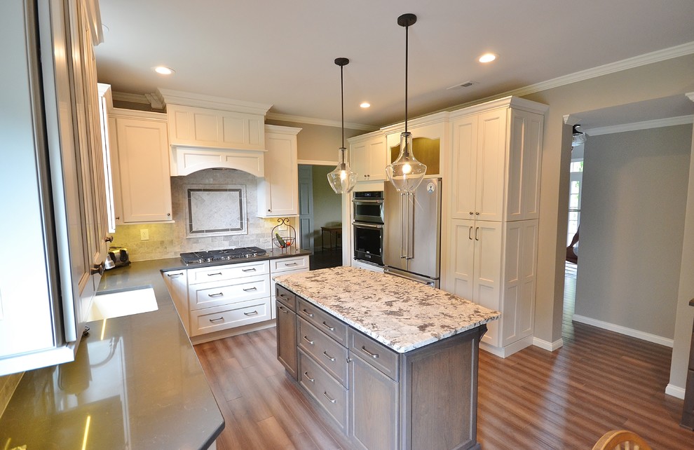 Eat-in kitchen - large transitional l-shaped medium tone wood floor eat-in kitchen idea in Philadelphia with an undermount sink, flat-panel cabinets, white cabinets, granite countertops, gray backsplash, subway tile backsplash, stainless steel appliances and an island