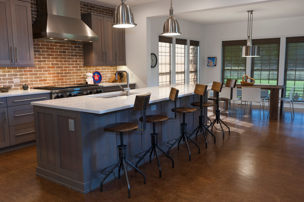 Large l-shaped cork floor and brown floor kitchen photo in Philadelphia with quartz countertops, stainless steel appliances, an island, an undermount sink, gray cabinets, brick backsplash and white countertops