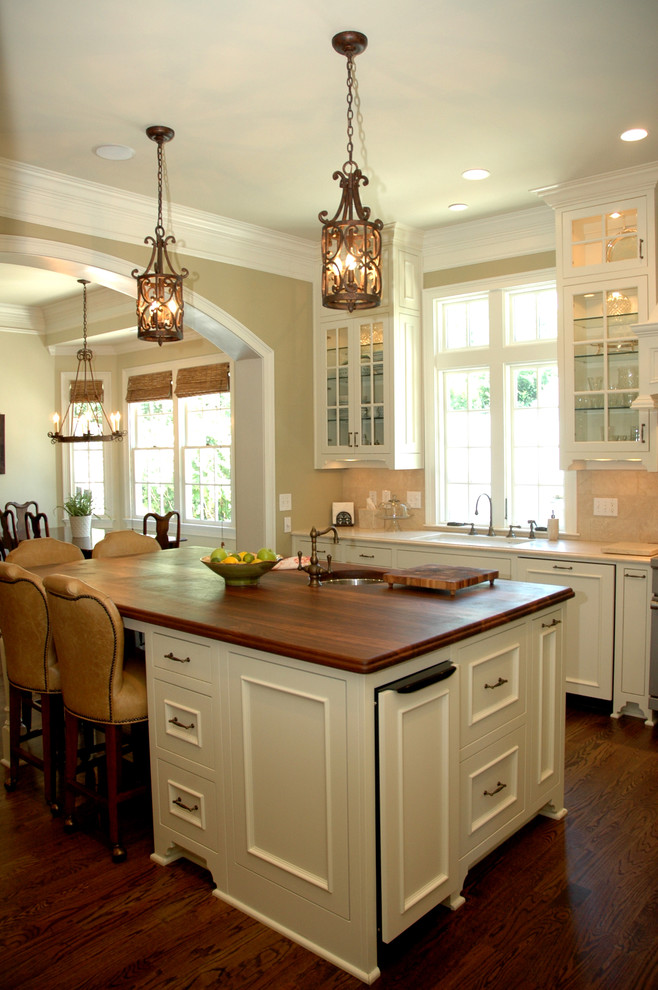 Elegant kitchen photo in Atlanta with wood countertops