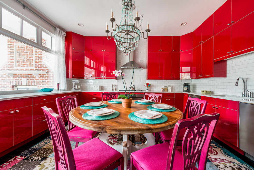 This is an example of a bohemian u-shaped kitchen/diner in Atlanta with a submerged sink, flat-panel cabinets, red cabinets, white splashback, metro tiled splashback, stainless steel appliances, no island, multi-coloured floors and grey worktops.
