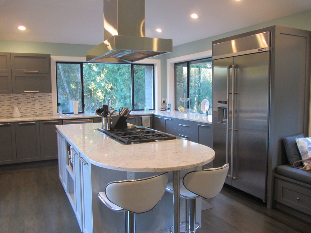 Large contemporary u-shaped kitchen/diner in Portland with a submerged sink, shaker cabinets, grey cabinets, marble worktops, grey splashback, matchstick tiled splashback, stainless steel appliances, laminate floors, an island and beige floors.