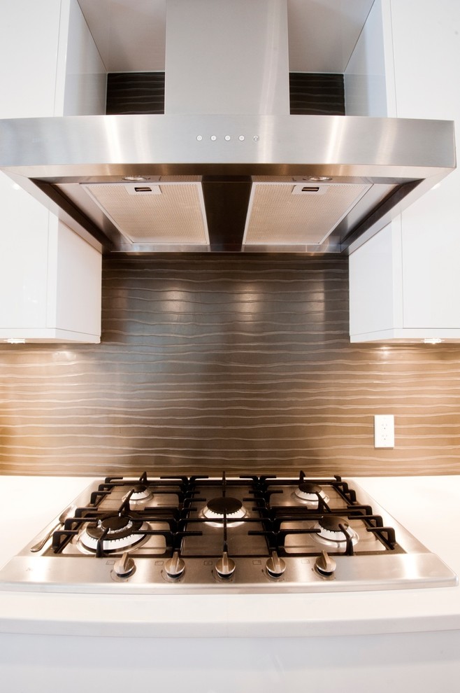 Example of a trendy kitchen design in Calgary with flat-panel cabinets, white cabinets and brown backsplash