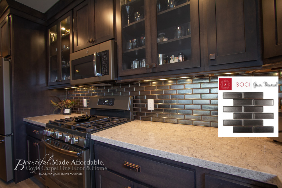 Example of a mid-sized trendy l-shaped ceramic tile and brown floor enclosed kitchen design in Other with an undermount sink, shaker cabinets, brown cabinets, quartz countertops, black backsplash, glass tile backsplash, stainless steel appliances, an island and white countertops