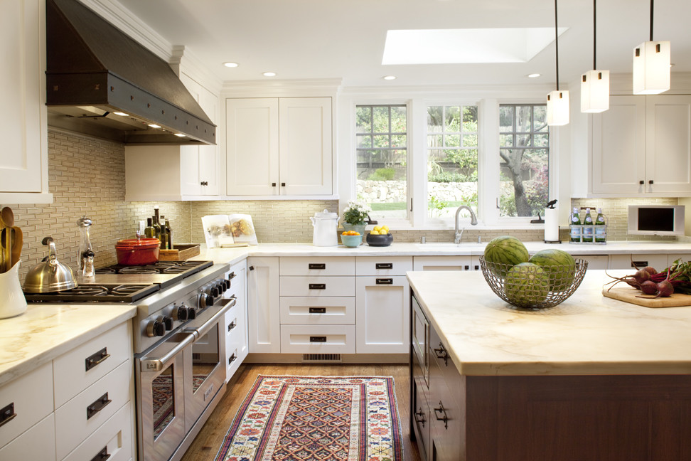 Large trendy medium tone wood floor eat-in kitchen photo in San Francisco with an undermount sink, shaker cabinets, white cabinets, glass tile backsplash, stainless steel appliances and an island
