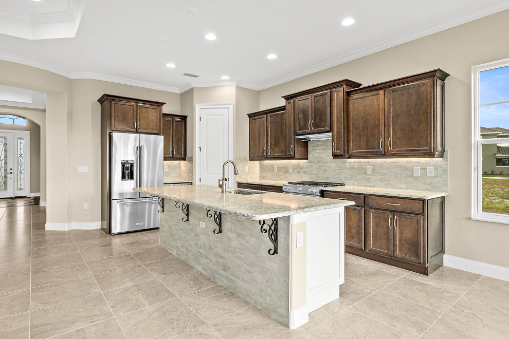 Kitchen - large transitional l-shaped ceramic tile and beige floor kitchen idea in Orlando with a single-bowl sink, beige cabinets, quartz countertops, beige backsplash, subway tile backsplash, stainless steel appliances, an island, beige countertops and recessed-panel cabinets