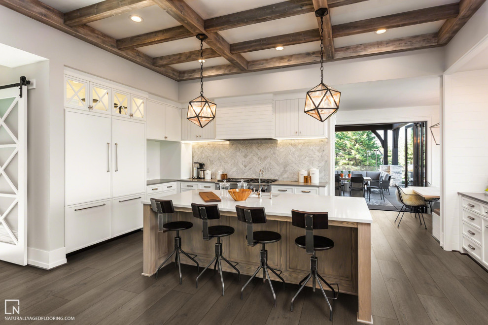 Große Küche mit weißen Schränken, Vinylboden, Kücheninsel, braunem Boden und freigelegten Dachbalken in Sonstige