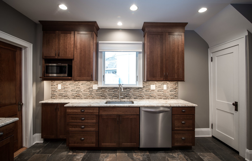 Mid-sized transitional u-shaped ceramic tile and brown floor eat-in kitchen photo in New York with an undermount sink, shaker cabinets, medium tone wood cabinets, granite countertops, beige backsplash, glass tile backsplash, stainless steel appliances, a peninsula and beige countertops