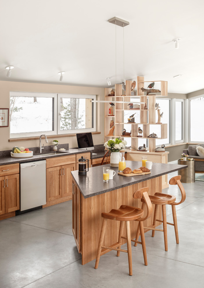 Photo of a small contemporary galley kitchen/diner in Portland Maine with medium wood cabinets and an island.
