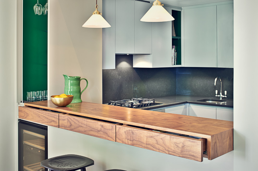 Inspiration for a small contemporary u-shaped eat-in kitchen remodel in Surrey with a peninsula