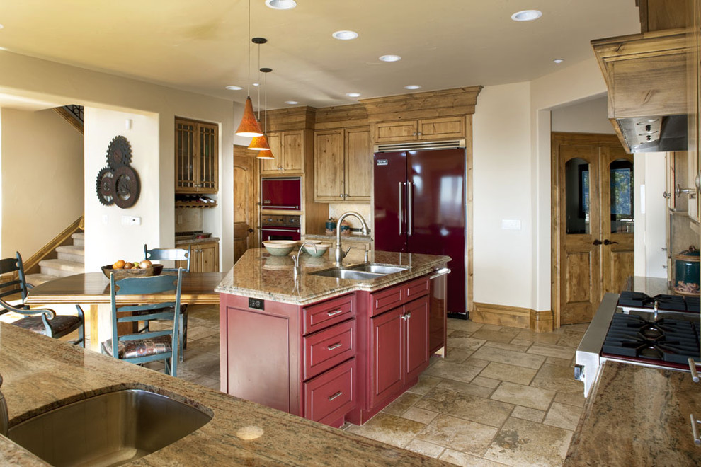 This is an example of a medium sized rustic l-shaped kitchen/diner in Denver with a double-bowl sink, shaker cabinets, medium wood cabinets, granite worktops, stainless steel appliances, ceramic flooring and an island.