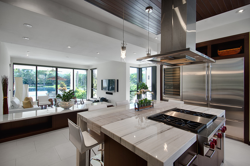 Photo of a contemporary u-shaped open plan kitchen in Miami with porcelain flooring and an island.