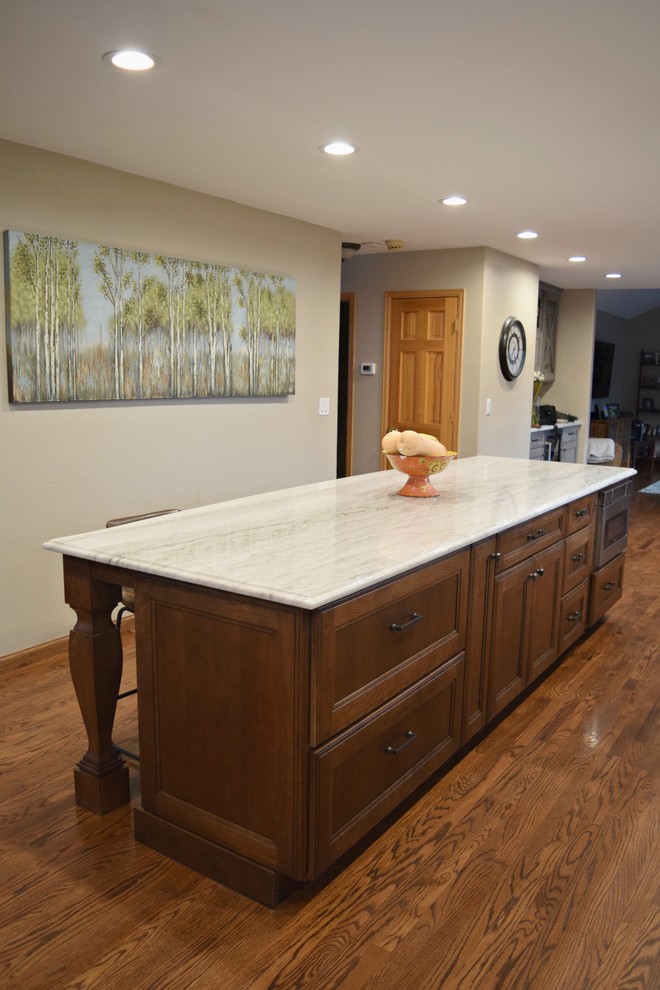Example of a huge transitional l-shaped medium tone wood floor open concept kitchen design in Denver with a farmhouse sink, flat-panel cabinets, gray cabinets, stainless steel appliances and an island