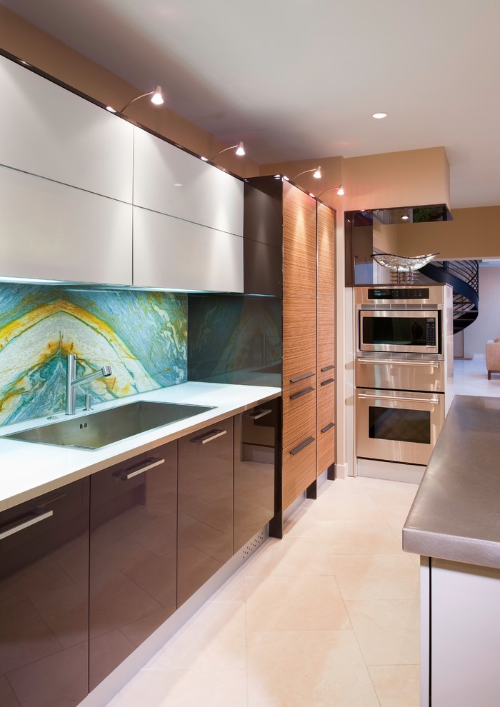 Modern inredning av ett mellanstort l-kök, med en nedsänkt diskho, släta luckor, bruna skåp, flerfärgad stänkskydd, rostfria vitvaror, en köksö och stänkskydd i sten