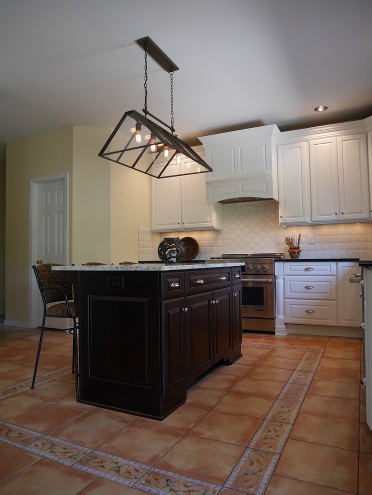Example of a large transitional l-shaped ceramic tile eat-in kitchen design in New York with a single-bowl sink, raised-panel cabinets, white cabinets, granite countertops, white backsplash, ceramic backsplash, stainless steel appliances and an island
