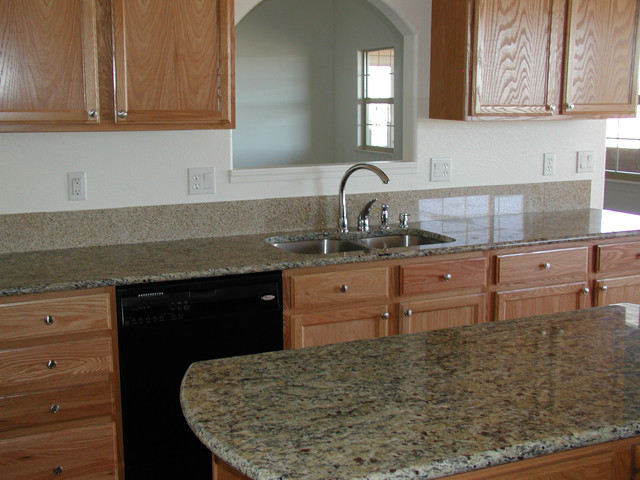 Example of a classic kitchen design in Denver with a double-bowl sink, medium tone wood cabinets, granite countertops, stainless steel appliances and an island