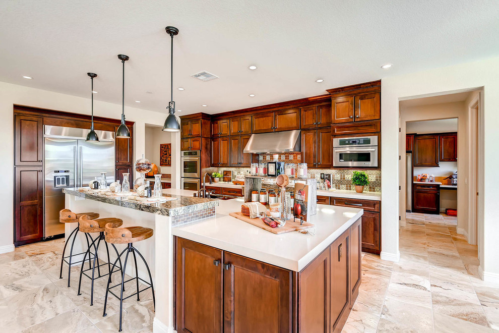 Example of a large transitional single-wall ceramic tile open concept kitchen design in Las Vegas with an undermount sink, recessed-panel cabinets, medium tone wood cabinets, granite countertops, brown backsplash, stone tile backsplash, stainless steel appliances and an island