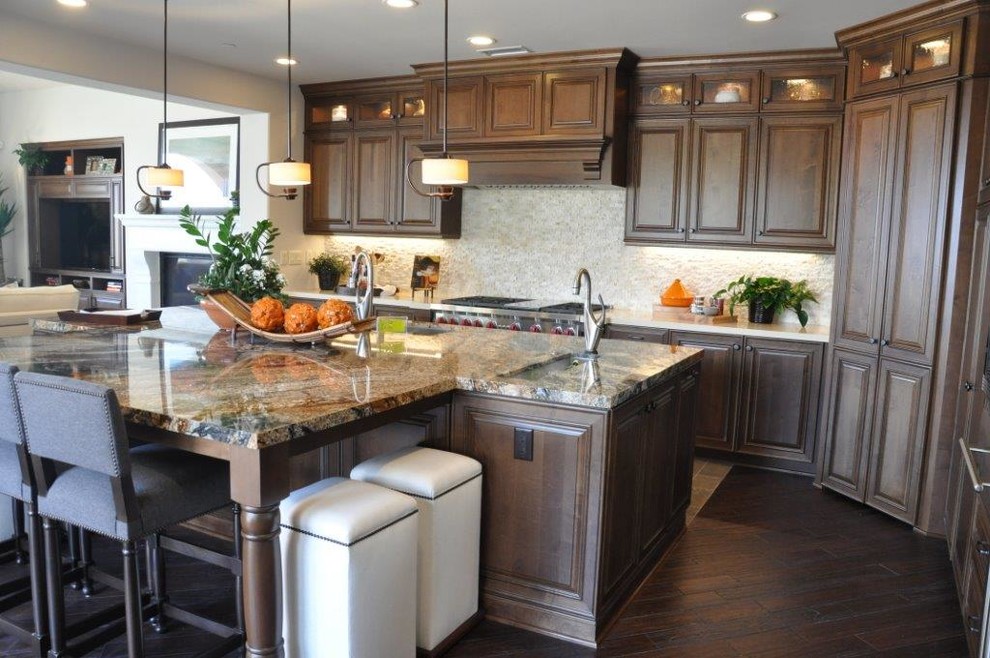 Photo of an expansive traditional open plan kitchen in Los Angeles with raised-panel cabinets and an island.