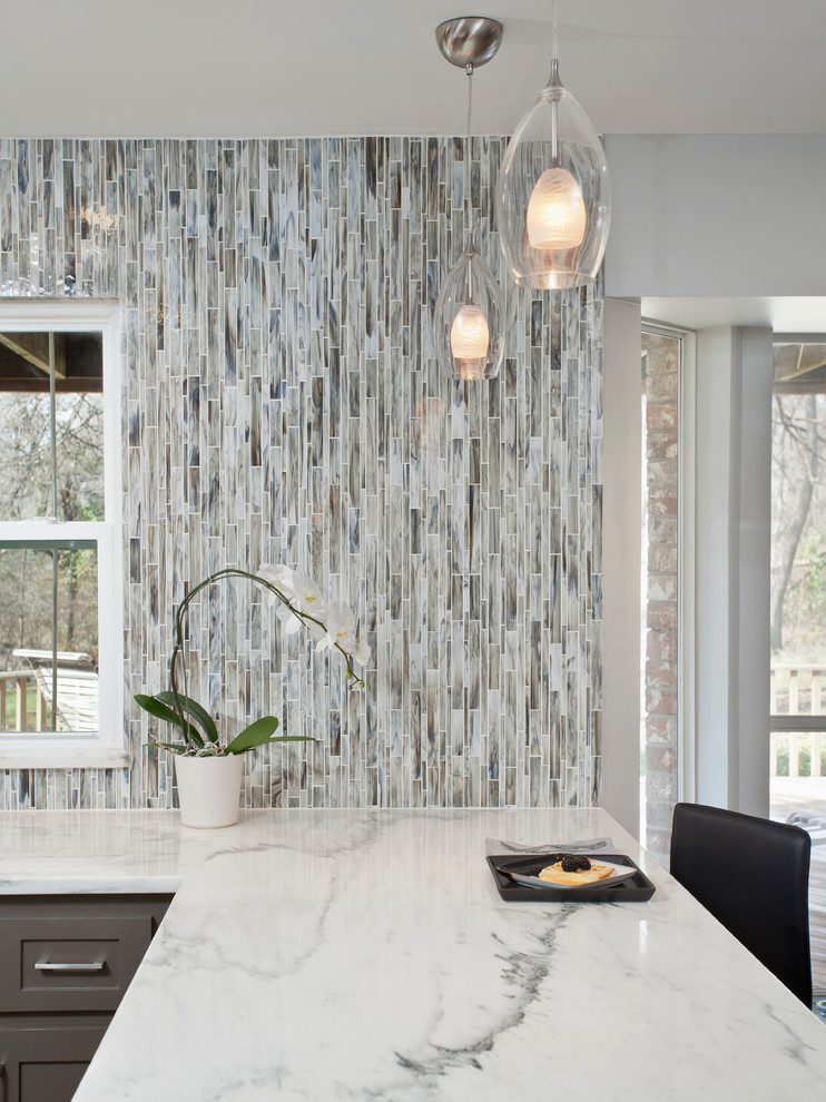 Example of a transitional l-shaped eat-in kitchen design in Dallas with shaker cabinets, gray cabinets, marble countertops, gray backsplash, no island, mosaic tile backsplash and white countertops