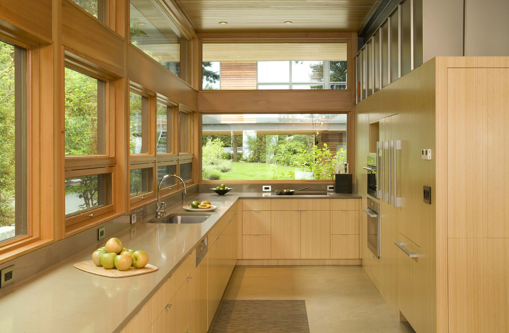 Trendy enclosed kitchen photo in Seattle with an undermount sink, flat-panel cabinets, light wood cabinets and quartz countertops
