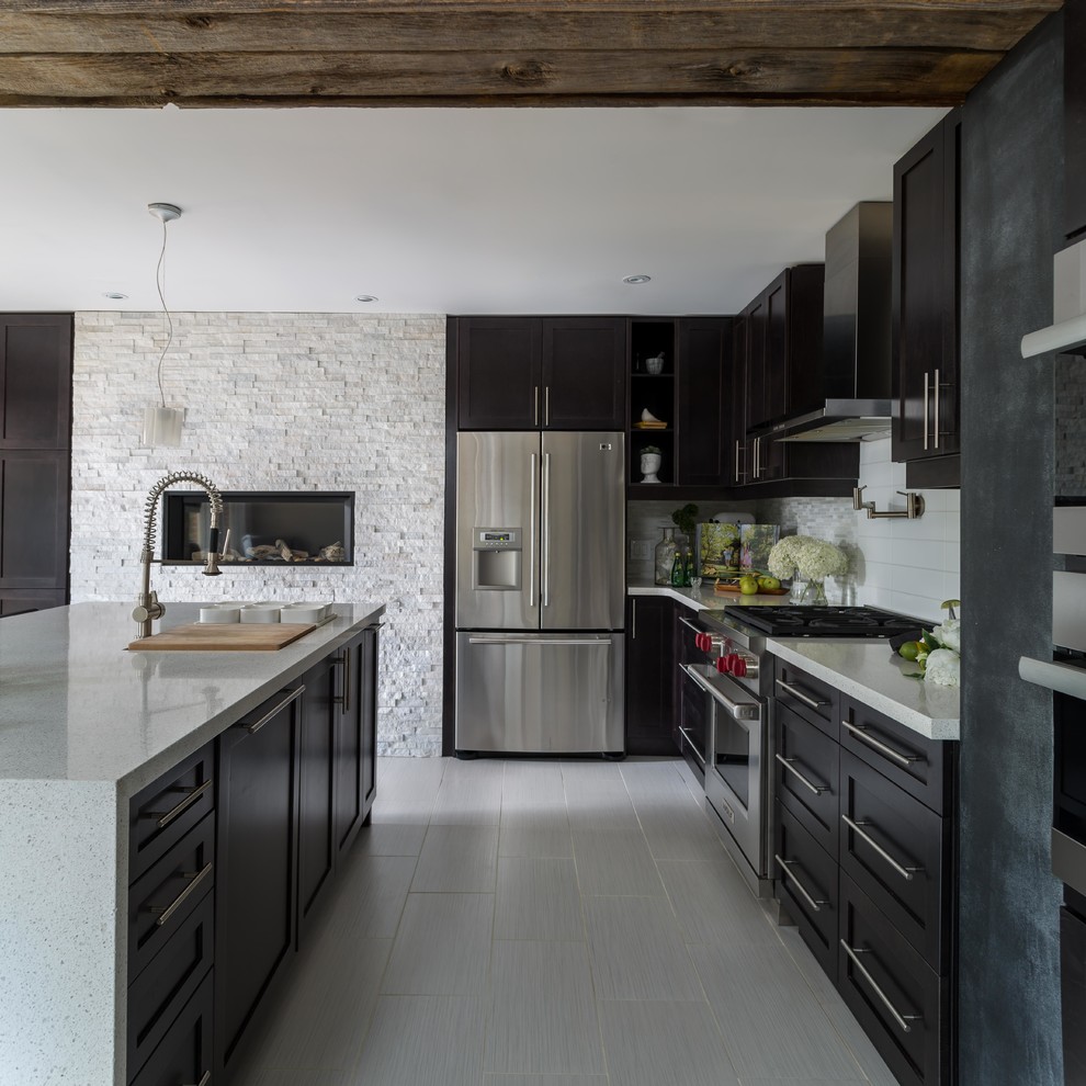 Inspiration for a large classic l-shaped open plan kitchen in Toronto with a submerged sink, shaker cabinets, black cabinets, grey splashback, metro tiled splashback, stainless steel appliances, porcelain flooring, an island and grey floors.