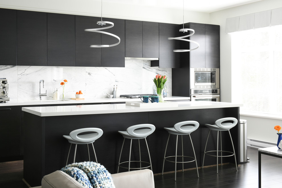 Inspiration for a mid-sized contemporary galley open concept kitchen remodel in Vancouver with flat-panel cabinets, quartz countertops, white backsplash and an island