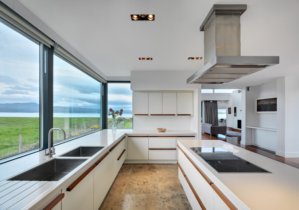 Inspiration for a large contemporary l-shaped open plan kitchen in Cork with an island, a double-bowl sink, flat-panel cabinets, white cabinets and white appliances.