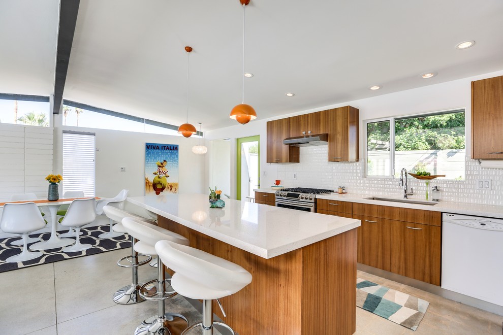 Open concept kitchen - mid-century modern galley gray floor and concrete floor open concept kitchen idea in Los Angeles with an undermount sink, flat-panel cabinets, medium tone wood cabinets, white backsplash, stainless steel appliances and an island