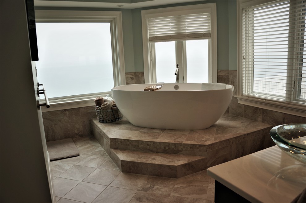 This is an example of a large coastal bathroom in Boston with raised-panel cabinets, white cabinets, porcelain flooring and brown floors.