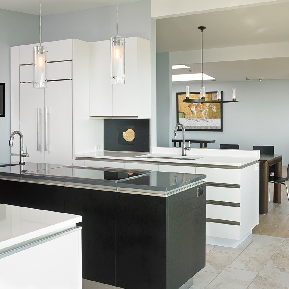 Medium sized contemporary galley open plan kitchen in Vancouver with a submerged sink, flat-panel cabinets, black cabinets, engineered stone countertops, black splashback, white appliances, porcelain flooring and an island.