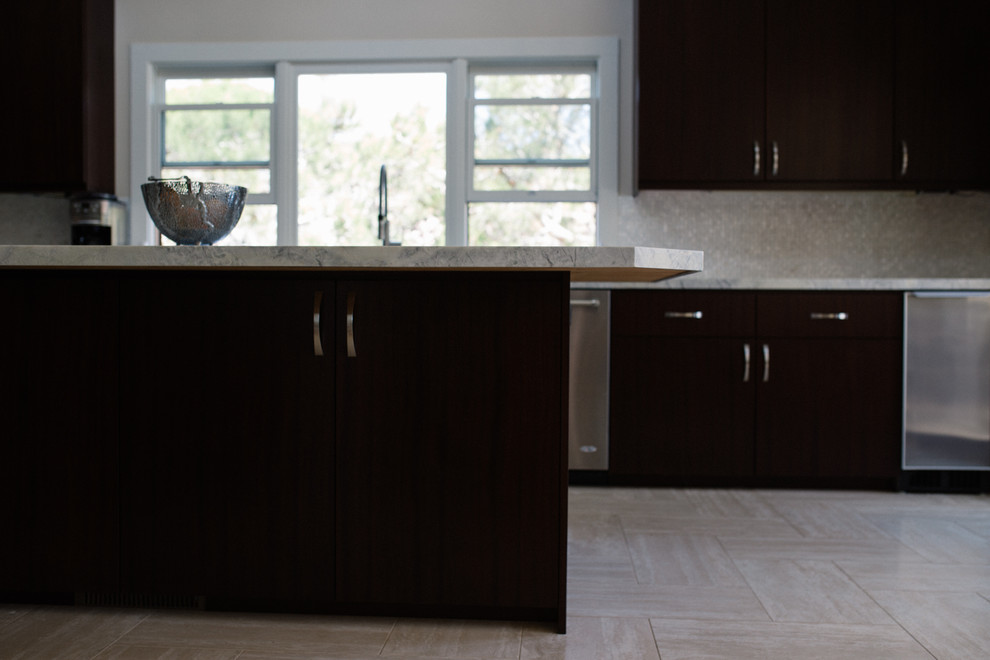 Medium sized modern u-shaped kitchen in San Diego with flat-panel cabinets, dark wood cabinets, white splashback, glass tiled splashback, stainless steel appliances, an island, a submerged sink and ceramic flooring.