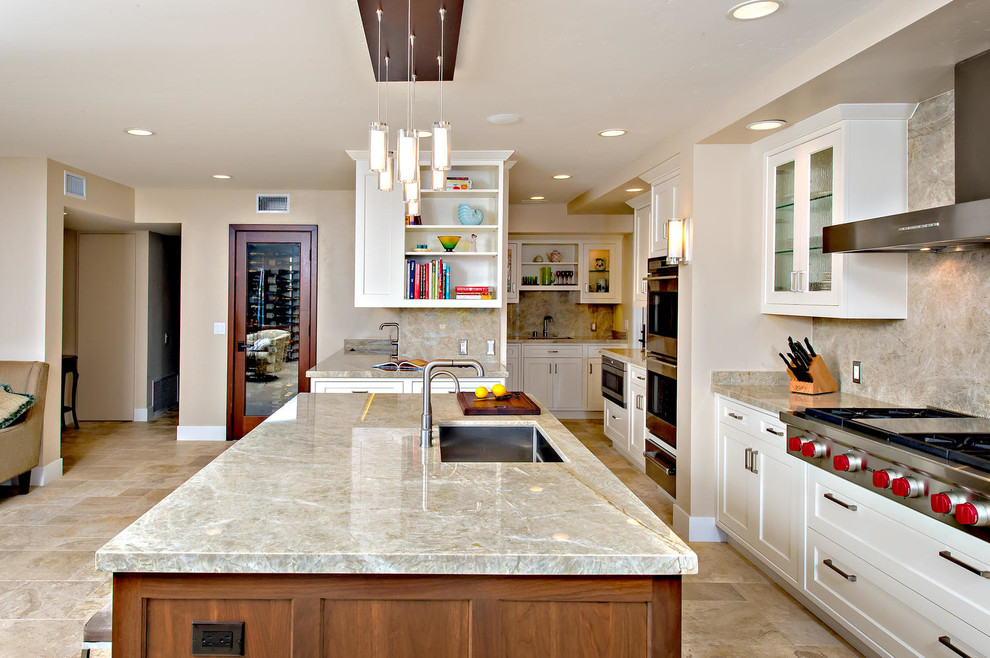 Inspiration for a large timeless u-shaped travertine floor enclosed kitchen remodel in San Diego with an undermount sink, shaker cabinets, white cabinets, granite countertops, multicolored backsplash, stone slab backsplash, stainless steel appliances and an island