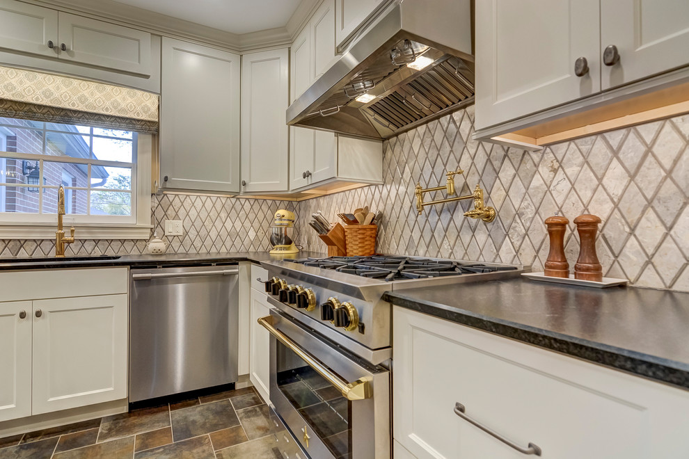 Example of a classic galley eat-in kitchen design in St Louis with an undermount sink, white cabinets, granite countertops and an island