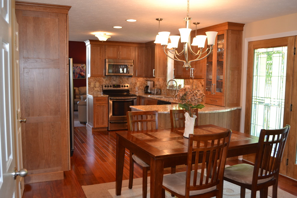 Example of a mid-sized classic l-shaped dark wood floor eat-in kitchen design in Boston with an undermount sink, recessed-panel cabinets, medium tone wood cabinets, granite countertops, multicolored backsplash and stainless steel appliances