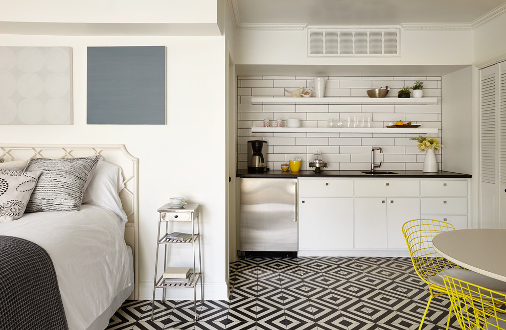 Small traditional single-wall kitchen in Nashville with a single-bowl sink, open cabinets, white splashback, metro tiled splashback, stainless steel appliances and multi-coloured floors.