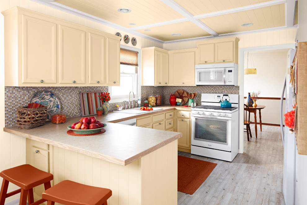 Exempel på ett mellanstort klassiskt kök, med en dubbel diskho, luckor med infälld panel, gula skåp, träbänkskiva, flerfärgad stänkskydd, stänkskydd i mosaik, vita vitvaror och ljust trägolv