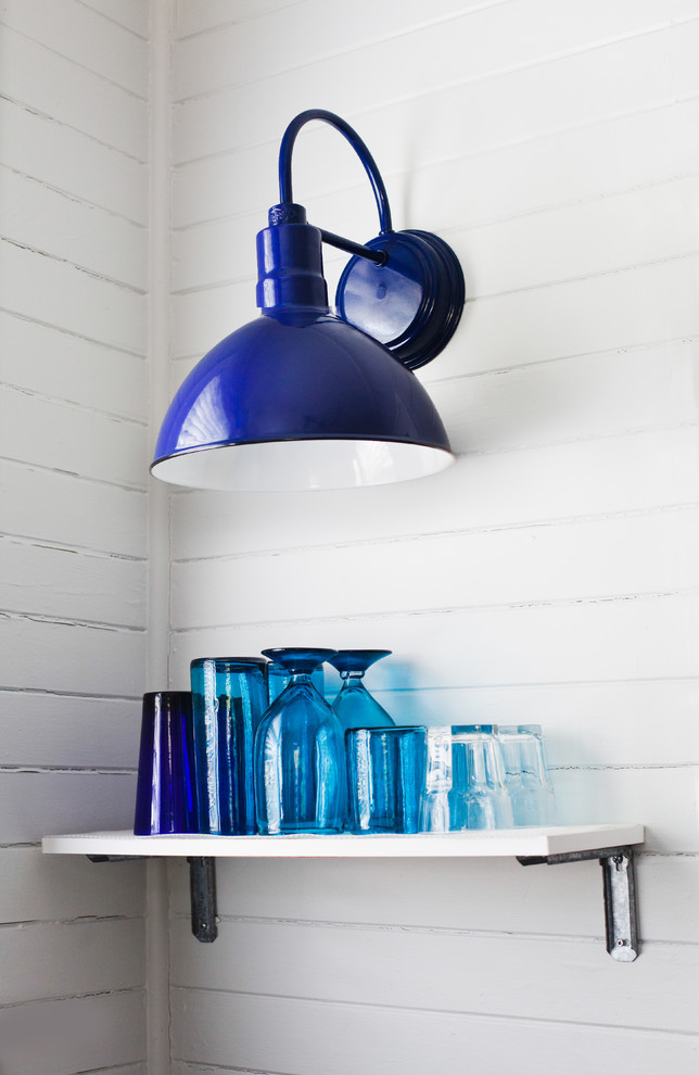 Porcelain Wall Sconce Illuminates Open Shelving in Kitchen Design