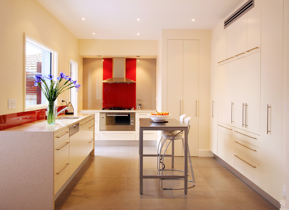 Contemporary kitchen in Melbourne with integrated appliances.