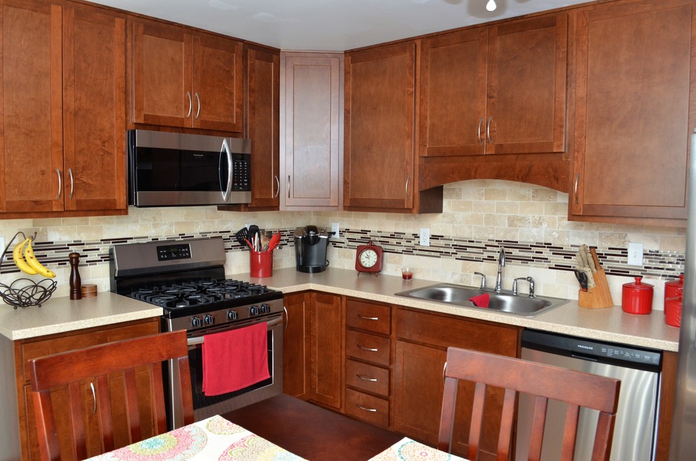 Mid-sized transitional l-shaped medium tone wood floor and brown floor eat-in kitchen photo in Other with a double-bowl sink, shaker cabinets, dark wood cabinets, limestone countertops, beige backsplash, limestone backsplash, stainless steel appliances, no island and beige countertops