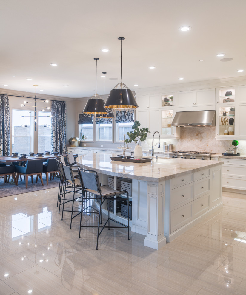 Large contemporary kitchen/diner in Los Angeles with a submerged sink, shaker cabinets, white cabinets, composite countertops, beige splashback, stone slab splashback, stainless steel appliances, porcelain flooring, an island, beige floors and beige worktops.