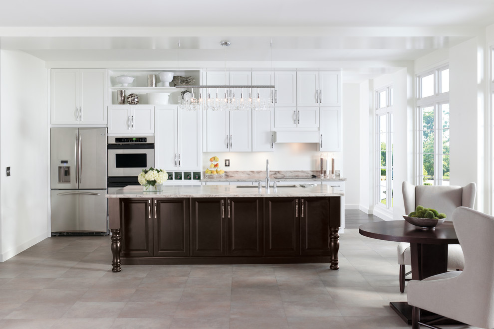Design ideas for a medium sized traditional single-wall kitchen/diner in New York with a submerged sink, shaker cabinets, white cabinets, marble worktops, stainless steel appliances, porcelain flooring and an island.