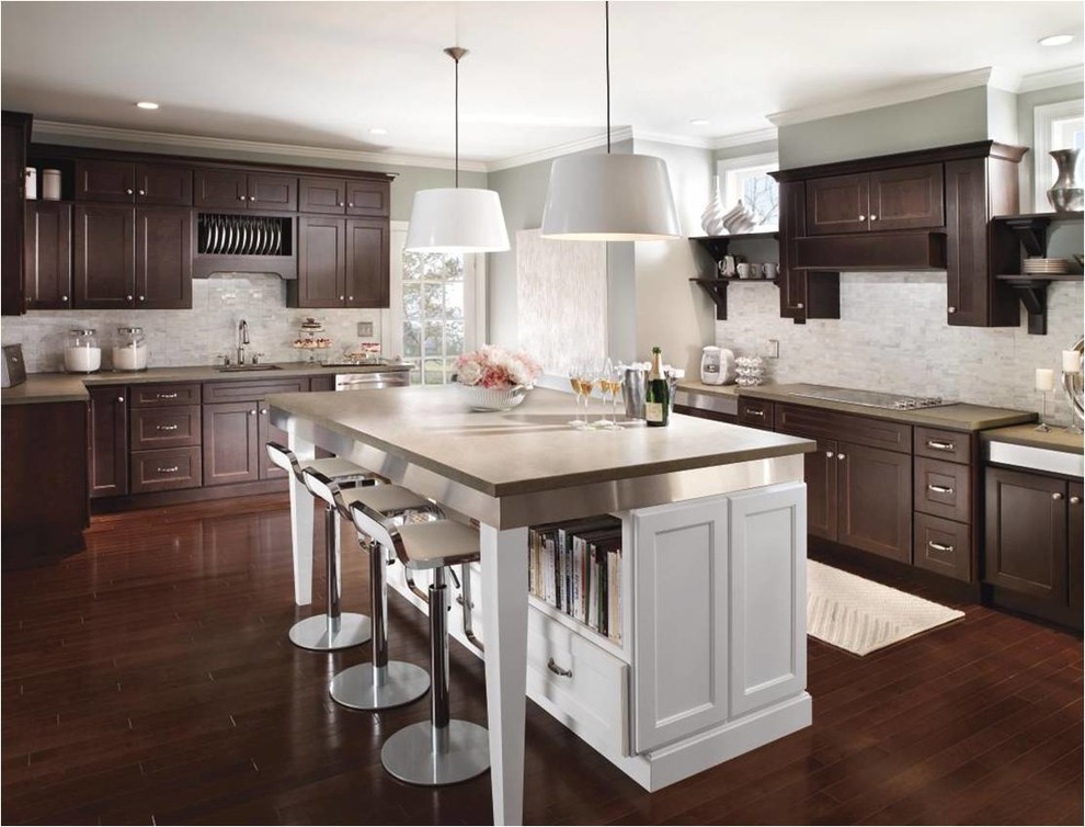 Example of a large classic l-shaped eat-in kitchen design in New York with shaker cabinets, dark wood cabinets, white backsplash and an island