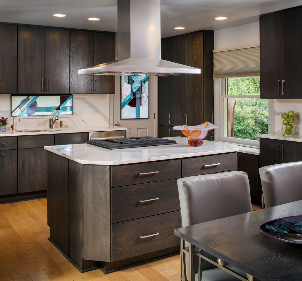 Inspiration for a medium sized contemporary kitchen/diner in DC Metro with a submerged sink, flat-panel cabinets, engineered stone countertops, white splashback, medium hardwood flooring, an island and dark wood cabinets.