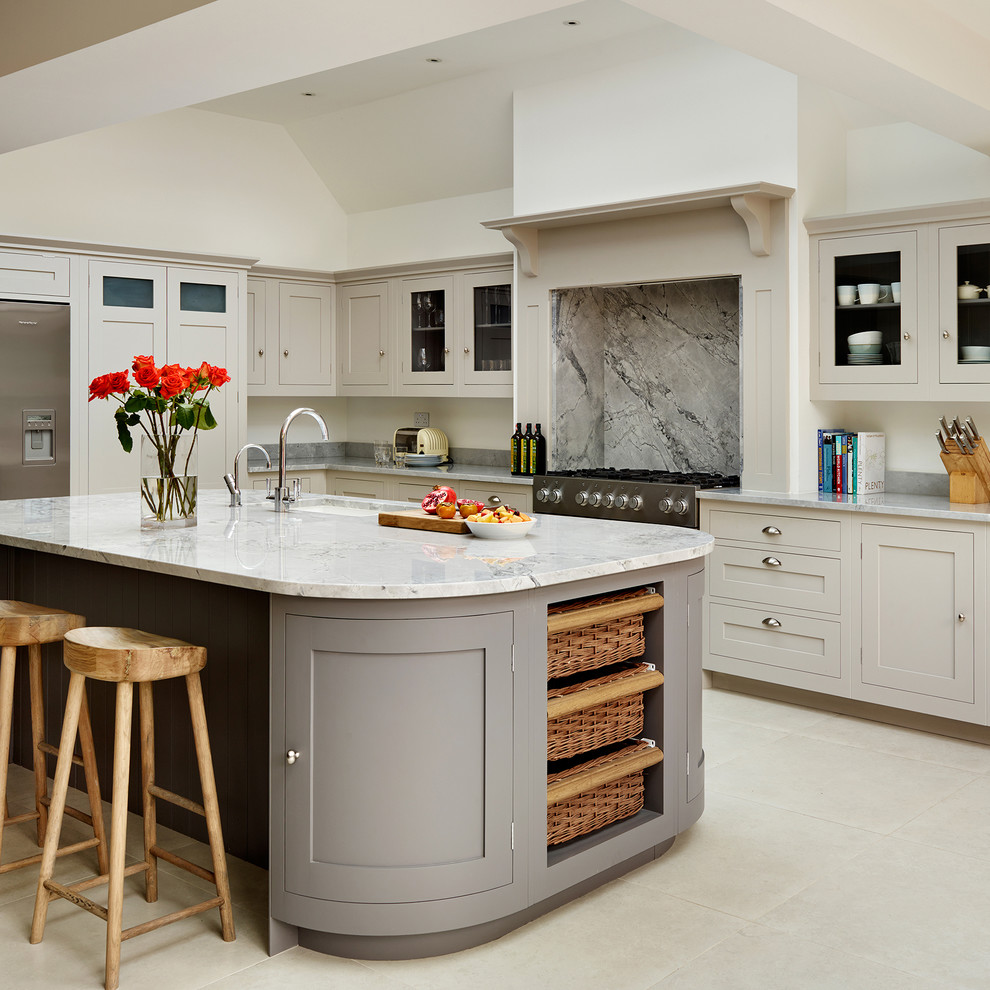 Inspiration for a timeless kitchen remodel in London with gray cabinets and an island