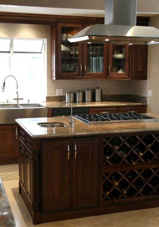 This is an example of a large classic l-shaped kitchen in San Francisco with a belfast sink, raised-panel cabinets, medium wood cabinets, granite worktops and stainless steel appliances.