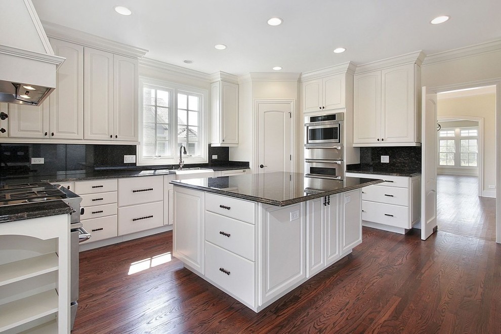 Inspiration for a huge modern u-shaped dark wood floor eat-in kitchen remodel in Baltimore with white cabinets, granite countertops, black backsplash, stainless steel appliances, an island and a farmhouse sink