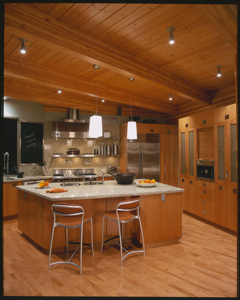 Bild på ett stort funkis kök, med en undermonterad diskho, släta luckor, skåp i ljust trä, granitbänkskiva, flerfärgad stänkskydd, stänkskydd i sten, rostfria vitvaror, ljust trägolv och en köksö