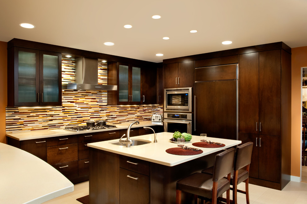 Trendy kitchen photo in DC Metro with an undermount sink, flat-panel cabinets, dark wood cabinets, multicolored backsplash, matchstick tile backsplash and paneled appliances