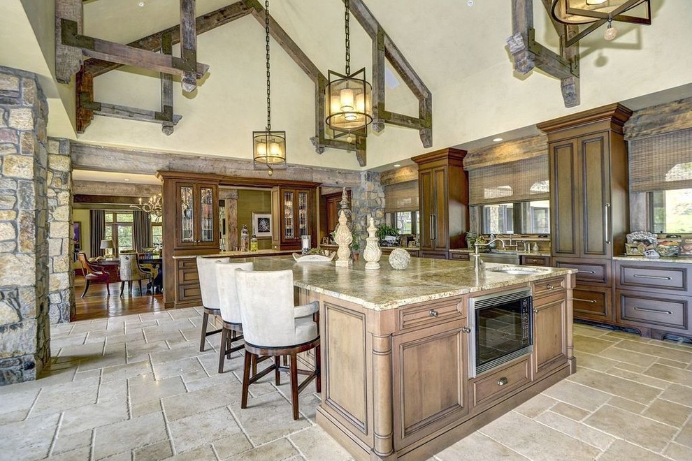 Huge mountain style galley limestone floor and beige floor eat-in kitchen photo in DC Metro with beaded inset cabinets, brown cabinets, granite countertops, beige backsplash, stainless steel appliances and an island